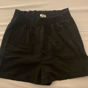 High waisted black shorts with detailed, elastic waist band